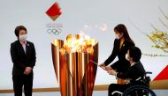 FILE PHOTO: Tokyo 2020 President Seiko Hashimoto looks on as actor Satomi Ishihara and Paralympian Aki Taguchi light the celebration cauldron on the first day of the Tokyo 2020 Olympic torch relay in Naraha, Fukushima prefecture, Japan March 25, 2021. REU