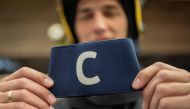 Djordje Vukicevic, duty firefighter, poses with Cristiano Ronaldo's armband which the Portugal captain threw on the pitch after his goal was disallowed in a World Cup qualifier against Serbia, at the Belgrade's firefighting brigade headquaters, Serbia, Ap
