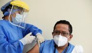 A healthcare worker receives a dose of the Pfizer-BioNTech coronavirus disease (COVID-19) vaccine at the Guasmo Hospital in Guayaquil, Ecuador, January 21, 2021. REUTERS/Santiago Arcos/File Photo