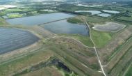 FILE PHOTO: A reservoir of an old phosphate plant, the site of a breach which is leaking polluted water into the surrounding area, prompting an evacuation order in Manatee County, is seen in an aerial photograph taken in Piney Point, Florida, U.S. April 3