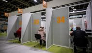 People register for the coronavirus disease (COVID-19) vaccination at the fairgrounds in Berlin, Germany, April 5, 2021. Michael Kappeler/Pool via REUTERS