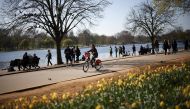 A person cycles through Hyde Park during sunny weather, amid the coronavirus disease (COVID-19) outbreak, in LONDON, Britain, April 4, 2021. REUTERS/Henry Nicholls
