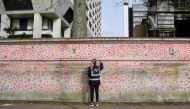 Volunteers and relatives of bereaved paint hearts along a wall beside St Thomas' hospital as a memorial to all those who have died so far in the UK from COVID-19, amid the spread of the coronavirus disease (COVID-19) pandemic in London, Britain, April 1, 