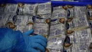 Workers pack halloumi cheese at the Petrou Bros Dairy in Aradippou, Cyprus, April 2, 2021. Picture taken April 2, 2021. REUTERS/Yiannis Kourtoglou