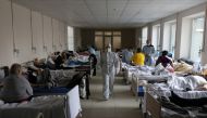 A medical specialist wearing personal protective equipment (PPE) walks in the medical college building which was converted into the coronavirus disease (COVID-19) ward of a local hospital in Lviv, Ukraine April 1, 2021. REUTERS/Roman Baluk
