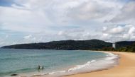 People are seen at an empty beach in Phuket, Thailand, March 31, 2021. Picture taken March 31, 2021. REUTERS/Jorge Silva