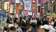 Pedestrians wearing protective face masks, amid the coronavirus disease (COVID-19) pandemic, are seen at a shopping district in Osaka, Japan, in this photo taken by Kyodo April 7, 2021. Mandatory credit Kyodo/via REUTERS