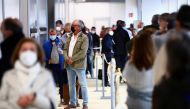 People wait in queue before receiving their first dose of the AstraZeneca COVID-19 vaccine, as the coronavirus disease (COVID-19) outbreak continues, at Enfermera Isabel Zendal hospital in Madrid, Spain, April 6, 2021. REUTERS/Sergio Perez
