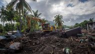 An excavator search for a body at an area affected by landslides triggered by tropical cyclone Seroja in East Flores, East Nusa Tenggara province, Indonesia April 8, 2021, in this photo taken by Antara Foto/Aditya Pradana Putra/via Reuters.