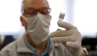 A doctor prepares a dose of the Pfizer-BioNTech coronavirus disease (COVID-19) vaccine in the eastern German town of Weisswasser, Germany, April 9, 2021. REUTERS/Michaela Rehle