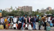 People wearing protective masks stand in line at a railway station amidst the spread of the coronavirus disease (COVID-19) in Mumbai, India, 9 April, 2021. REUTERS/Francis Mascarenhas