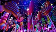 Guests pose for photos by an installation at the 