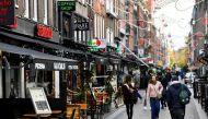 FILE PHOTO: People walk past restaurants following the new social restrictions announced by the Dutch government, as the Netherlands battle to control the spread of the coronavirus disease (COVID-19), in Amsterdam, Netherlands October 14 2020. REUTERS/Pir