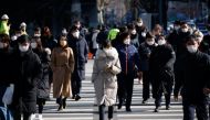 Commuters cross a zebra crossing, amid the coronavirus disease (COVID-19) pandemic in Seoul, South Korea, February 3, 2021. REUTERS/Kim Hong-Ji
