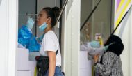 Healthcare workers take nasal swab samples from local residents for a COVID-19 test after hundreds of residents of Watthana district and the trendy Thonglor neighborhood tested positive for the coronavirus disease (COVID-19) in Bangkok, Thailand, April 8,