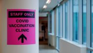 FILE PHOTO: FILE PHOTO; A sign for a COVID-19 vaccination clinic is seen as high-risk workers receive the first vaccines in the state of Victoria's rollout of the program, in Melbourne, Australia, February 22, 2021. REUTERS/Sandra Sanders/File Photo
