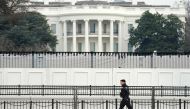 A member of the Secret Service walks along security fence installed around the White House days after supporters of U.S. President Donald Trump stormed the Capitol in Washington, U.S., January 11, 2021. REUTERS/Kevin Lamarque/File Photo