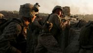 File photo: US Marines fire during a Taliban ambush as they carry out an operation to clear an area in Helmand province, Afghanistan, October 9, 2009. Reuters/Asmaa Waguih/File Photo