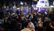 People enjoy the evening at an outside restaurant area in Soho, as the coronavirus disease (COVID-19) restrictions ease, in London, Britain April 12, 2021. REUTERS/Henry Nicholls
