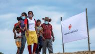 File photo: Venezuelan refugees walk to a school where a temporary shelter has been set up, to receive medical assistance and humanitarian aid from the Colombian Red Cross, in Arauquita, Colombia March 28, 2021. Reuters/Luisa Gonzalez/File Photo