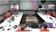 The team at NASA's Jet Propulsion Laboratory (JPL) in Southern California, U.S., react after the Mars helicopter Ingenuity's first flight on the planet on April 19, 2021 in this still image taken from a video. 