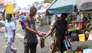 A Congolese man buys groceries at an open air market, amid concerns about the spread of coronavirus disease (COVID-19) in Kinshasa, Democratic Republic of Congo, March 28, 2020. REUTERS/Kenny Katombe/File Photo