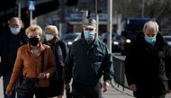 People wearing protective masks walk in Warsaw, Poland, April 2, 2021. REUTERS/Kacper Pempel/File Photo