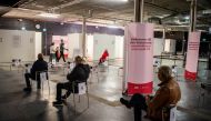 People wait to get a vaccine against the coronavirus disease (COVID-19) at a night club which was turned into a mass vaccination center, in Stockholm, Sweden, April 16, 2021. Carl-Olof Zimmerman/TT News Agency/via REUTERS