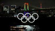FILE PHOTO: The Rainbow Bridge and Tokyo Tower are illuminated with Olympic colours to mark 100 days countdown to the Tokyo 2020 Olympics that have been postponed to 2021 due to the coronavirus disease (COVID-19) outbreak, in Tokyo, Japan April 14, 2021. 