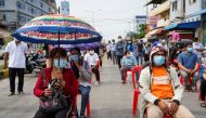 People wait in line before being vaccinated against coronavirus disease (COVID-19) in Phnom Penh, Cambodia, April 22, 2021. REUTERS/Cindy Liu