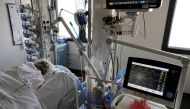 A patient suffering from the coronavirus disease (COVID-19) is treated in the Intensive Care Unit (ICU) at the hospital in Valenciennes, France, April 22, 2021. REUTERS/Pascal Rossignol