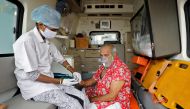 FILE PHOTO: A paramedic uses an oximeter to check the oxygen level of a patient inside an ambulance while waiting to enter a COVID-19 hospital for treatment, amidst the spread of the coronavirus disease (COVID-19) in Ahmedabad, India, April 22, 2021. REUT