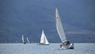 Boats prepare to line up on Leman Lake to reveal the invisible French-Swiss border during an artistic event called 