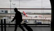 FILE PHOTO: A man walks through a terminal at Paris Charles de Gaulle airport near Paris, February 5, 2021. REUTERS/Gonzalo Fuentes/File Photo