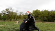 Aerial acrobat, Eszter Kovacs, performs during a performance of the Utca-SZAK street theatre group, amid the coronavirus disease (COVID-19) pandemic, in Budapest, Hungary, May 2, 2021. Picture taken May 2, 2021. Reuters/Bernadett Szabo