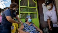 Francia Nolasco, 78, gets a shot of China's Sinovac coronavirus disease (COVID-19) vaccine at home, administered by health workers at Marikina, Metro Manila, Philippines, May 5, 2021. REUTERS/Eloisa Lopez