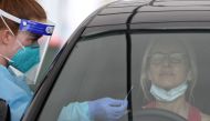 A medical worker swabs a member of the public at the Bondi Beach drive-through coronavirus disease (COVID-19) testing centre as the city experiences an outbreak in Sydney, Australia, December 21, 2020. REUTERS/Loren Elliott/File Photo