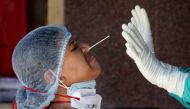 A woman reacts as a healthcare worker takes a nasal swab sample for a coronavirus disease (COVID-19) test at a government-run hospital, amidst the spread of the disease in Kolkata, India, May 6, 2021. REUTERS/Rupak De Chowdhuri TPX IMAGES OF THE DAY
