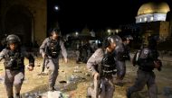 Israeli police run during clashes with Palestinians at the compound that houses Al-Aqsa Mosque in Jerusalem's Old City on May 7, 2021. (Reuters/Ammar Awad)