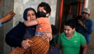 Palestinians evacuate following an Israeli airstrike on a building in Gaza City May 11, 2021. Reuters/Mohammed Salem