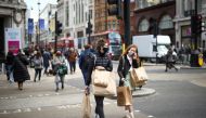 People walk at Oxford Street, as the coronavirus disease (COVID-19) restrictions ease, in London, Britain April 12, 2021. REUTERS/Henry Nicholls
