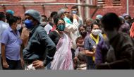 People wearing protective face masks wait to receive their second dose of COVISHIELD, a coronavirus disease (COVID-19) vaccine manufactured by Serum Institute of India, outside a vaccination centre in Kolkata, India, May 12, 2021. REUTERS/Rupak De Chowdhu