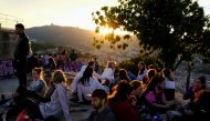 People gather at a lookout point, with a view of the city of Barcelona in the background, as the state of emergency decreed by the Spanish Government to prevent the spread of the coronavirus disease (COVID-19) is due to end on Sunday, in Barcelona, Spain,