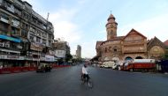 A man rides his bicycle during a lockdown to limit the spread of the coronavirus disease (COVID-19) in Mumbai, India, April 23, 2021. REUTERS/Niharika Kulkarni/File Photo