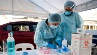Health workers sort documents before administering the coronavirus disease (COVID-19) vaccine at a drive-thru vaccination site for bedridden and persons with disabilities, in Makati city, Metro Manila, Philippines, May 7, 2021. REUTERS/Lisa Marie David