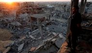 FILE PHOTO: A Palestinian man looks out of his heavily damaged house at neighbouring houses which witnesses said were destroyed during the Israeli offensive, in the east of Gaza City September 3, 2014. REUTERS/Suhaib Salem/File Photo
