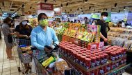 People wait to pay for their groceries after the government advised people to reduce leaving their homes and limit gatherings due to an increasing number of locally transmitted COVID-19 infections, in Taipei, Taiwan, May 15, 2021. Reuters/Ann Wang