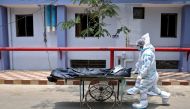 Healthcare workers transfer the body of a person who died from the coronavirus disease (COVID-19), inside a hospital premises in Kolkata, India, May 12, 2021. REUTERS/Rupak De Chowdhuri