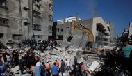 Rescue workers search for victims amid rubble at the site of Israeli air strikes, in Gaza City May 16, 2021. (REUTERS/Mohammed Salem)