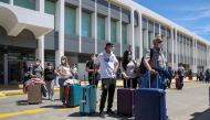 Passengers arriving from Germany and Switzerland line up outside the terminal of the Heraklion airport, as the country's tourism season officially opens, on the island of Crete, Greece, May 15, 2021. Reuters/Stefanos Rapanis